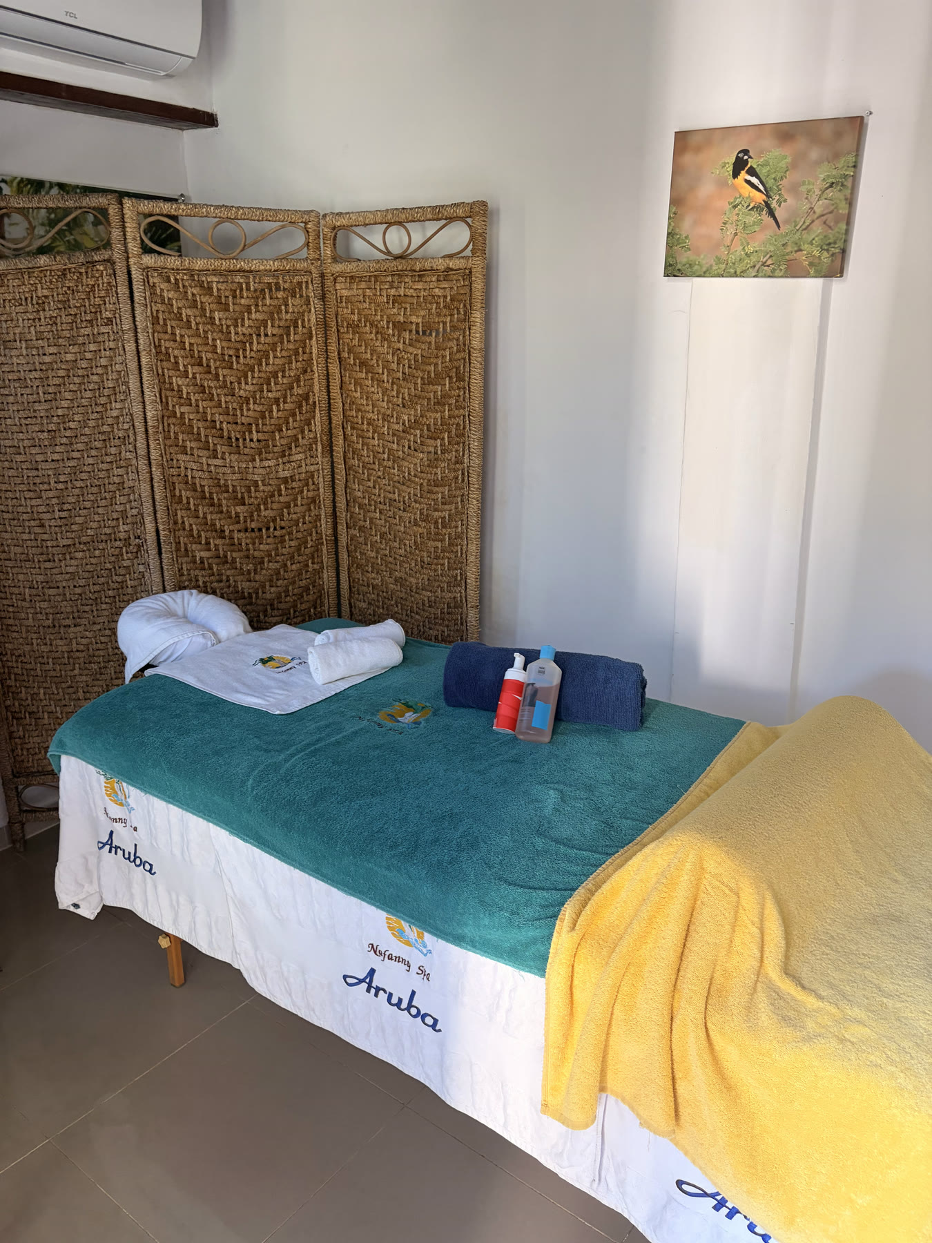 A softly lit corner of the treatment room with folded towels and candles
