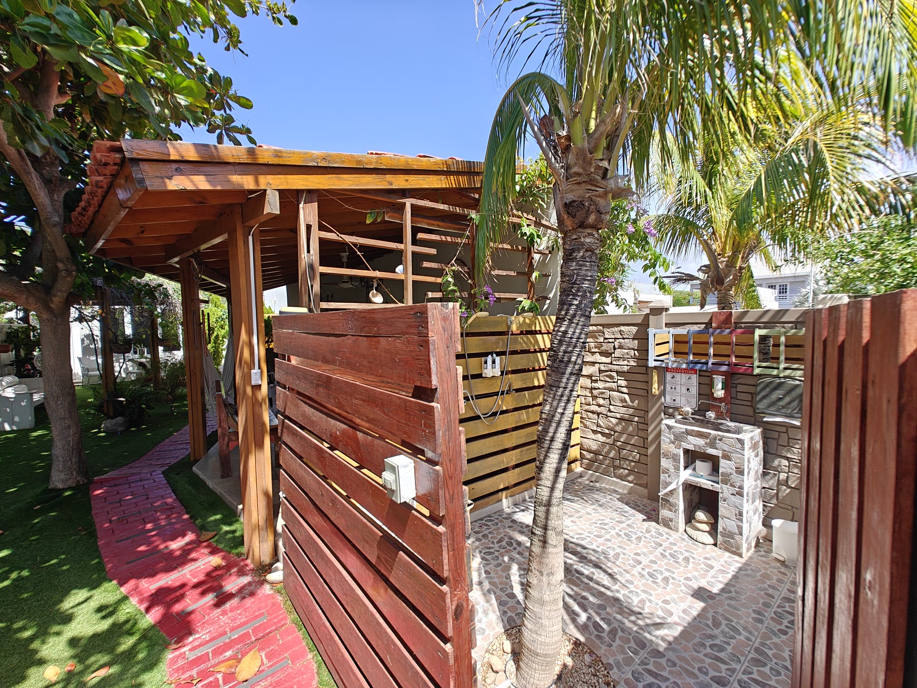 The open-air garden shower, screened by tropical planting