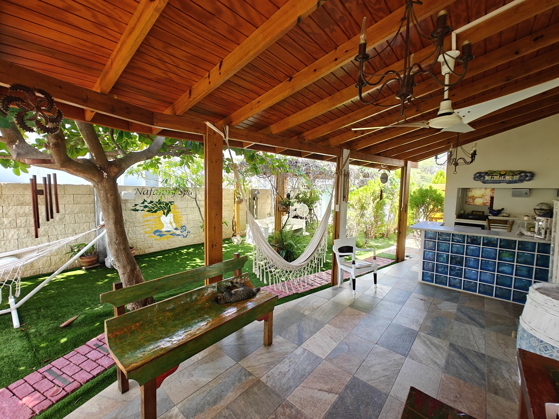 Wide view of the reception area with rattan seating and hanging plants